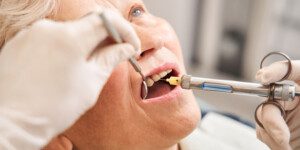 woman at dentist office getting local anesthesia injection into gums